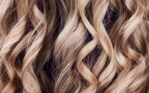 Falujące, blond włosy z subtelnymi refleksami, jak po artystycznym flamboyage.